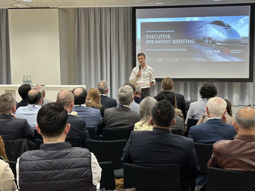 A Citeline speaker before the audience of the executive breakfast briefing at the Swiss Biotech Day 2026, its title slide on the screen behind