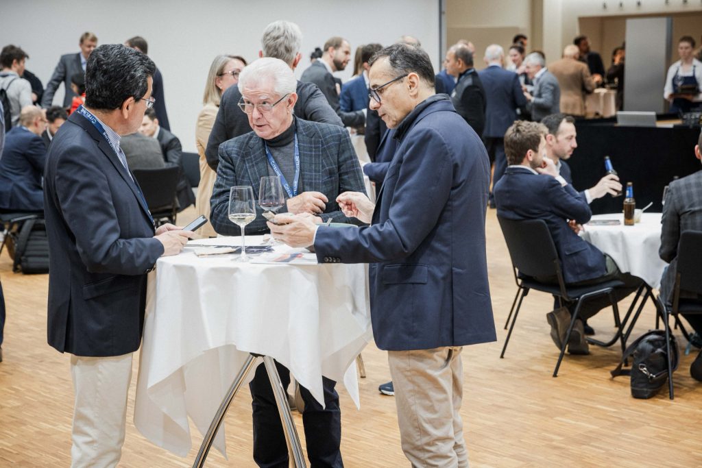 Investors in conversation at a standing table at the biotech investors' apéro of the Swiss Biotech Day 2024